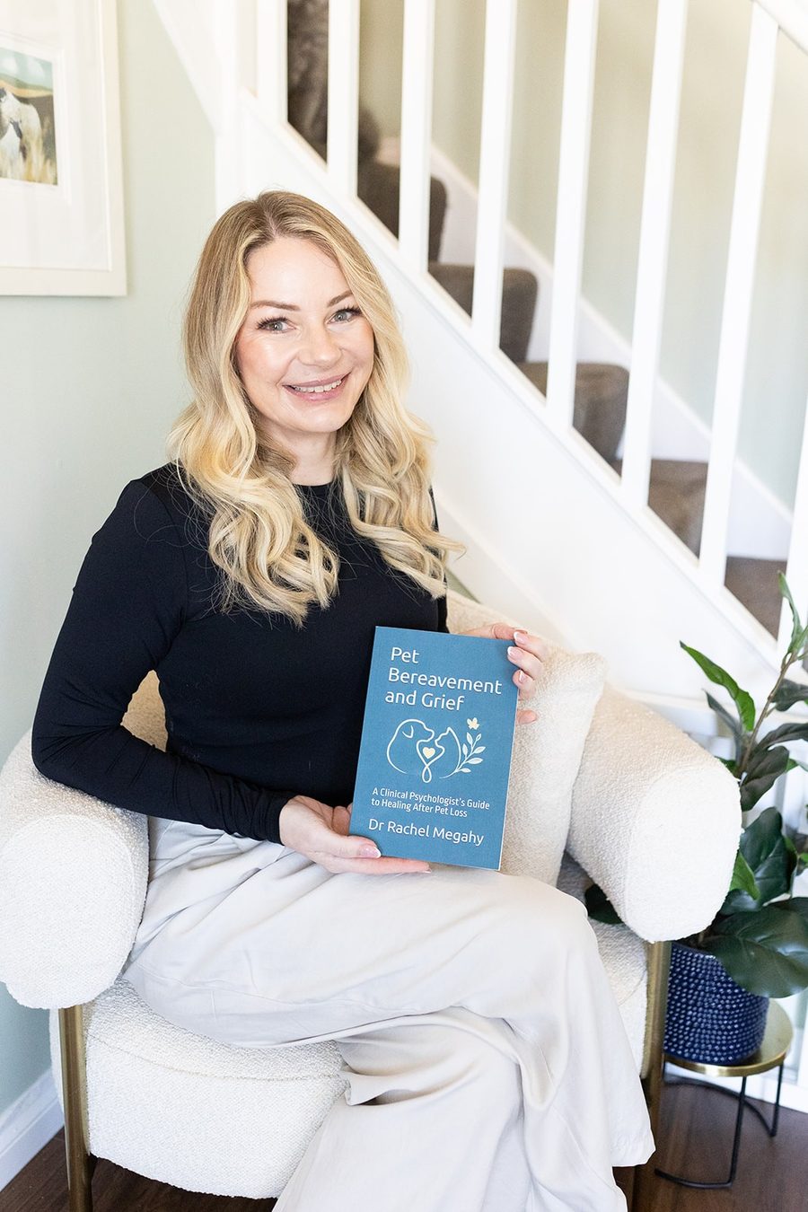 Dr Rachel Megahy holding her book, Pet Bereavement and Grief.